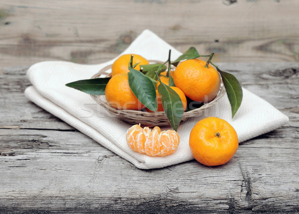 tangerines with leaves in a beautiful basket on wooden table Stock photo © inxti