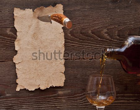 Stock photo: Old paper pinned to a wooden wall with a knife