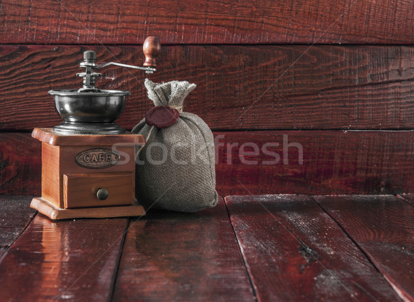 Coffee mill with burlap sack full of roasted coffee beans over w Stock photo © inxti