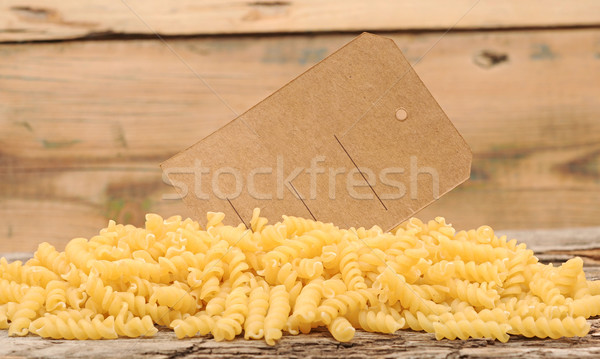 pile fusilli pasta with blank tag on wood background  Stock photo © inxti