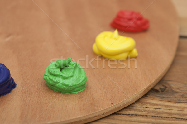 Oil paint on a palette sitting on a wood background. Focus on gr Stock photo © inxti