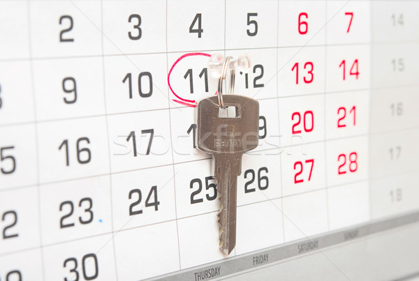 A house key on a calendar background, paying your mortgage on ti Stock photo © inxti