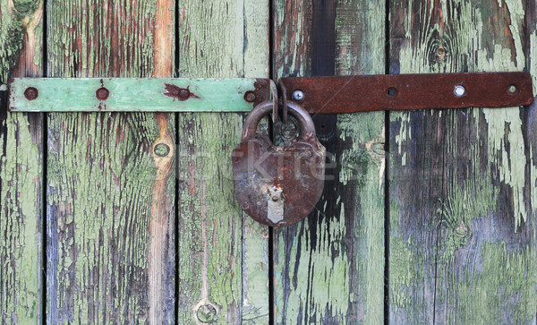 Old wooden doors locked with rusty padlock  Stock photo © inxti