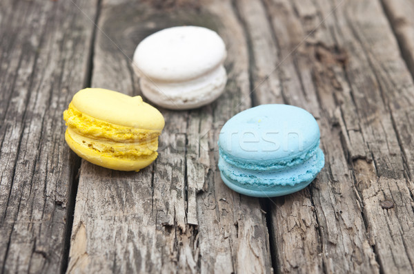 Colorful macaroons, delicious French pastries, stacked on table. Stock photo © inxti