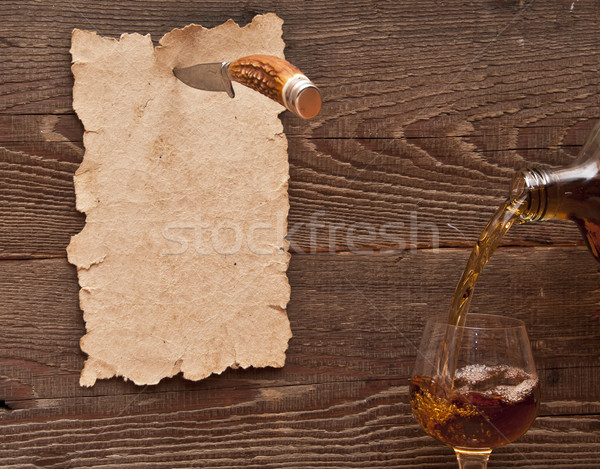 Old paper pinned to a wooden wall with a knife Stock photo © inxti