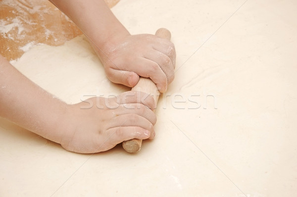 Child's hands kneading dough on wooden table Stock photo © inxti