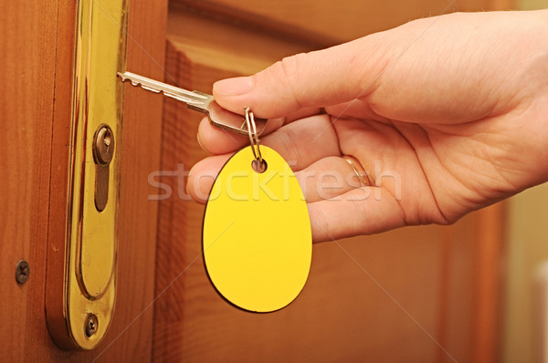 Hand and key with empty label Stock photo © inxti