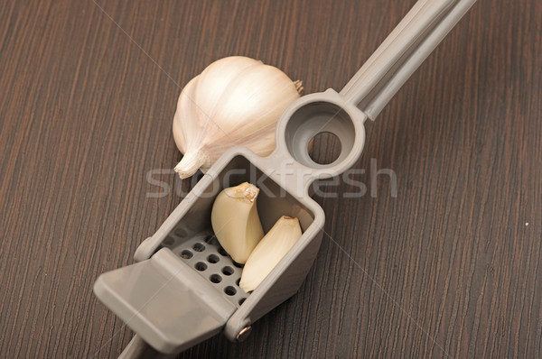 raw garlic in a metal press.  Stock photo © inxti