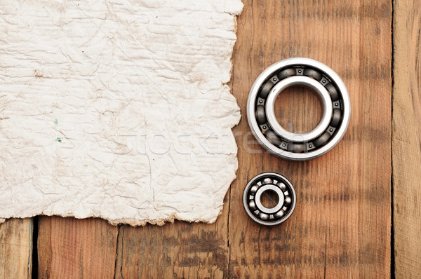 steel ball bearings with old paper on wooden table. space for yo Stock photo © inxti