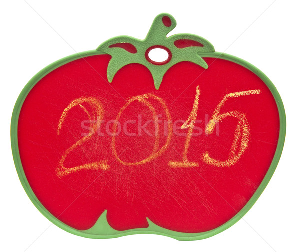 Stock photo: 2015 on chalkboard in shape of tomato over white background