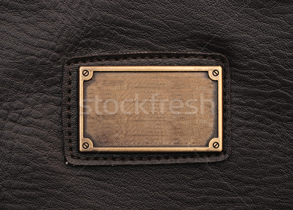 metal label on old black leather background Stock photo © inxti