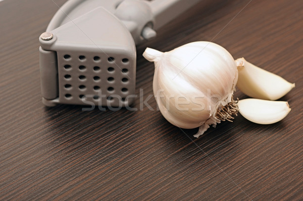 Garlic press and garlic Stock photo © inxti