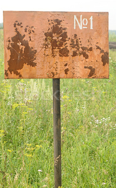 Weathered plaque on a grassy land plot  Stock photo © inxti
