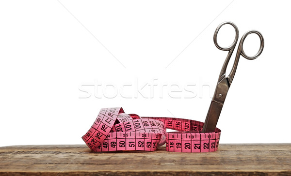 Old scissors and measuring tape on wooden background  Stock photo © inxti