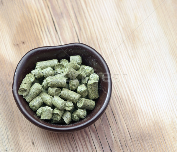 beer ingredients: toppellets of hops on wooden table Stock photo © inxti