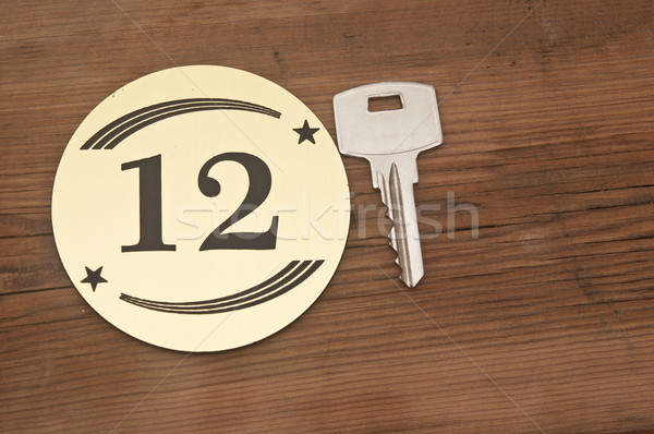 Hotel suite key with room number 12 on wood table  Stock photo © inxti