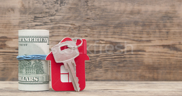 House keys over the hundred dollar banknotes against wooden back Stock photo © inxti