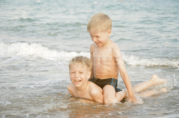 Happy twin children enjoying summer day on a beach  Stock photo © inxti