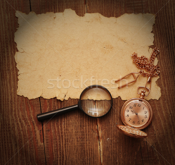 old paper with pocket watch and magnifying glass Stock photo © inxti