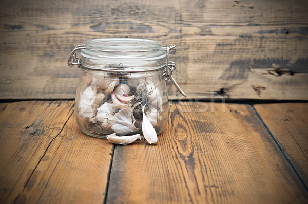 fresh garlic in glass jar  on old wooden table Stock photo © inxti