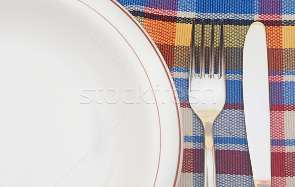 Table setting with fork, knife, plates, and napkin Stock photo © inxti