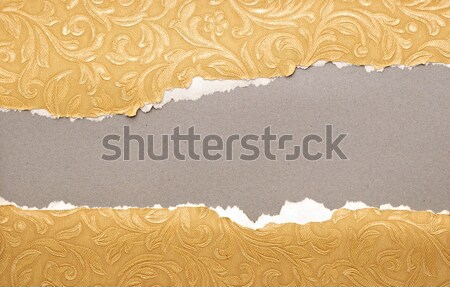 Torn paper - golden paper ripped apart showing underlying layer  Stock photo © inxti