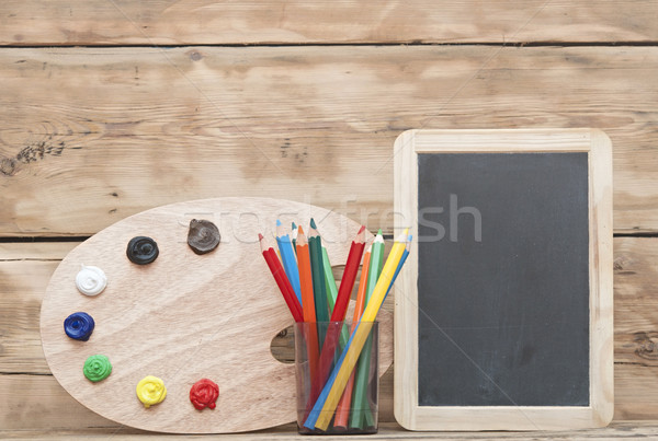 Wooden easel with clean paper and wooden artists palette loaded  Stock photo © inxti