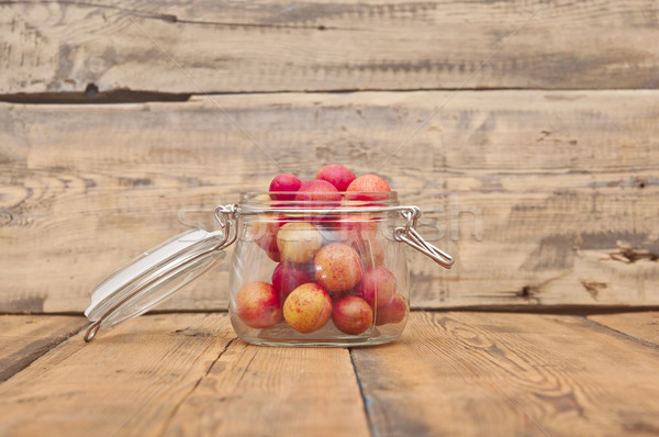 freshly picked plum in glass jar on old wooden table  Stock photo © inxti