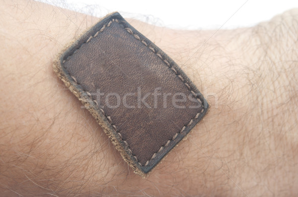 Blank jeans label sewed on a hand isolated over white  Stock photo © inxti