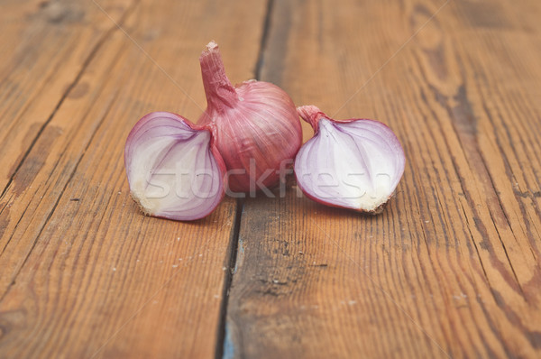 Red sliced onion on old wooden table Stock photo © inxti