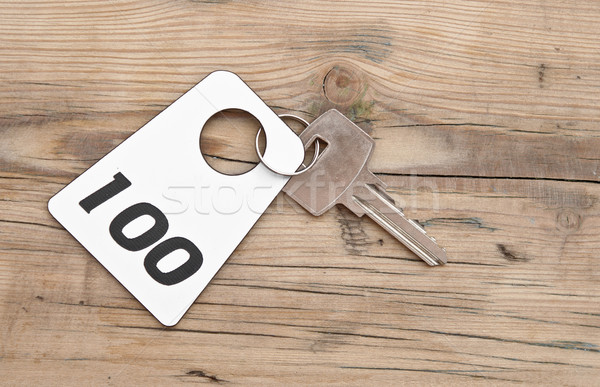 Hotel suite key with room number 100 on wood table  Stock photo © inxti