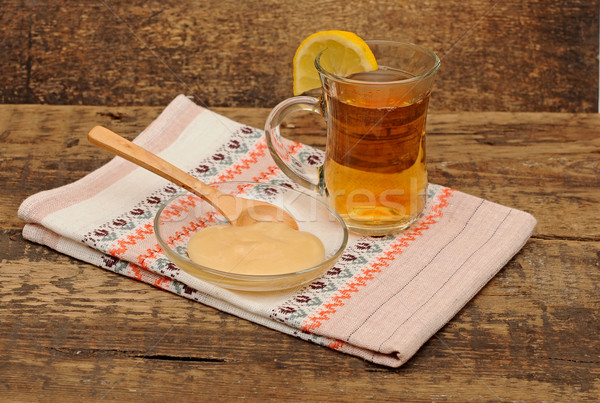 glass cup of tea with honey on colorful napkin Stock photo © inxti