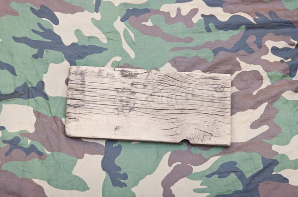 close up of an empty wooden sign on military fabric Stock photo © inxti