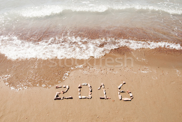 2016 written in sand on sunny beach Stock photo © inxti