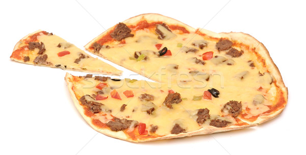 Pizza with a slice removed. Isolated on white. Stock photo © inxti