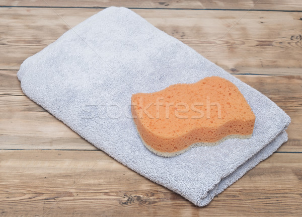 Sponge and towel on wood background Stock photo © inxti