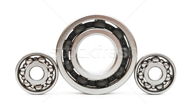 Big and small ball bearings on white background  Stock photo © inxti