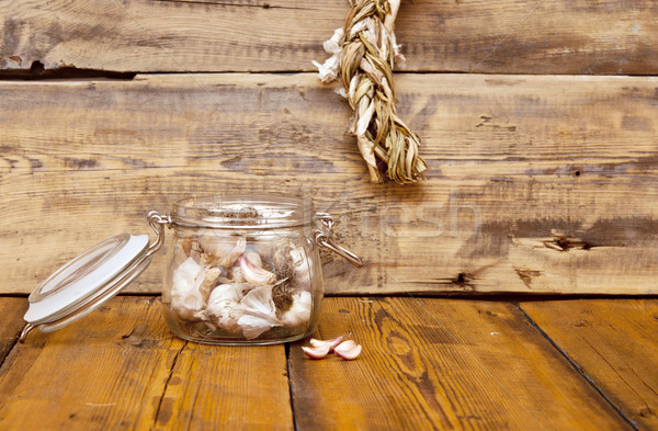 fresh garlic in glass jar  on old wooden table Stock photo © inxti