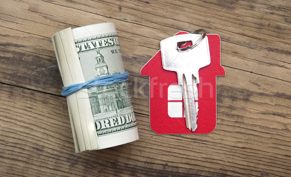 House keys over the hundred dollar banknotes against wooden back Stock photo © inxti