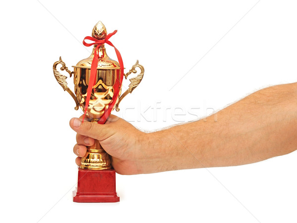 Man holding a champion golden trophy on white background Stock photo © inxti