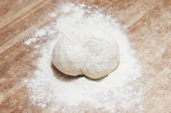 Sprinkle flour on dough Stock photo © inxti