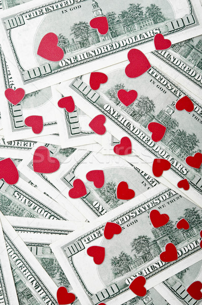 a small red hearts on a pile of dollar bills Stock photo © inxti
