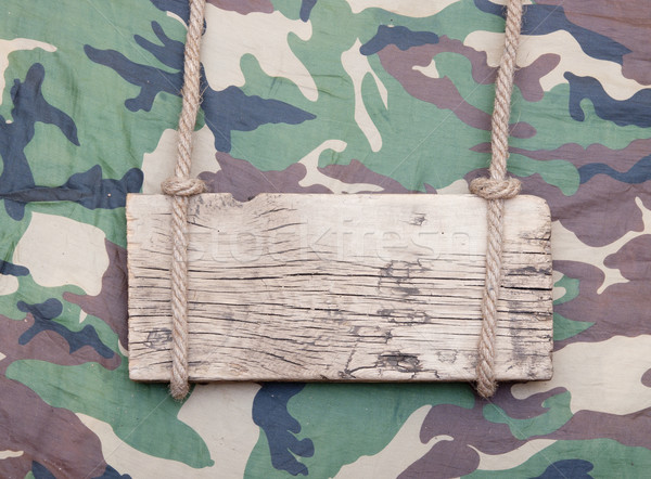 close up of an empty wooden sign hanging on a rope on military f Stock photo © inxti