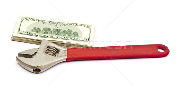 Wrench and bills of U.S. dollar currency isolated on white backg Stock photo © inxti