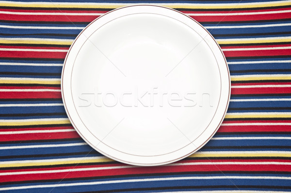 Empty plate on colorful tablecloth Stock photo © inxti