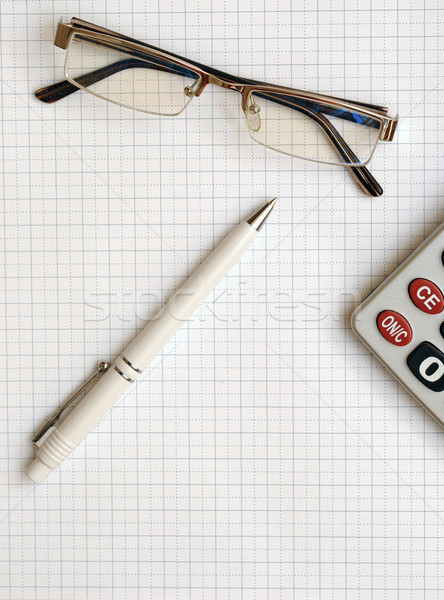 pen, eyeglass, and calculator on the working paper Stock photo © inxti