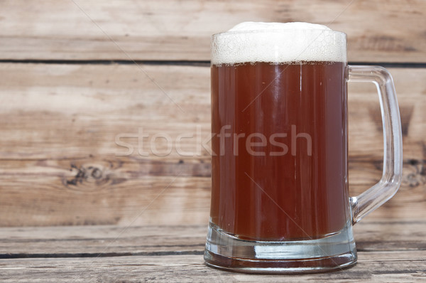 Stock photo: Mug of beer close up on wooden table 