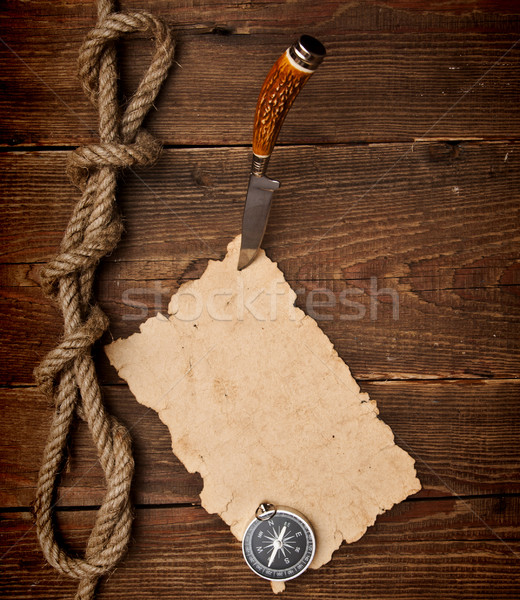 Old paper pinned to a wooden wall with a knife Stock photo © inxti