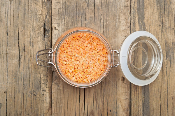 top views red split lentils in a jar on a wooden background Stock photo © inxti