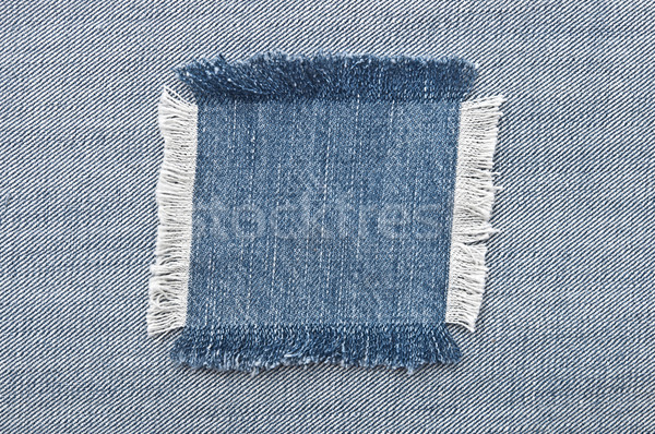 Closeup of blank jeans patch on inner side of worn blue denim Stock photo © inxti
